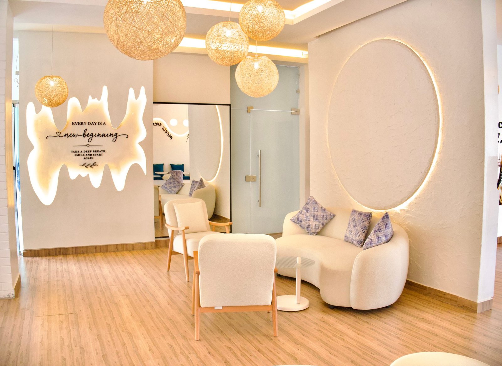Café Naimora reading nook with curved sofa, globe pendant lights and the new beginning wall