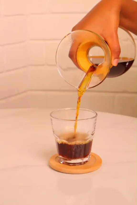 Chemex pour-over coffee being poured into a glass