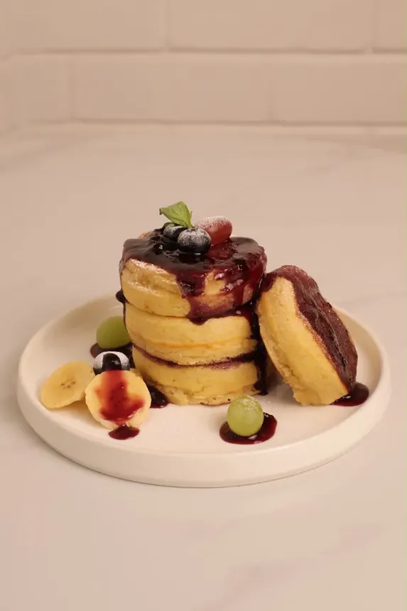 Fluffy Mini Pancakes stacked with chocolate sauce and berries